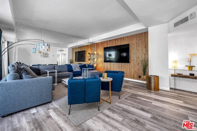 living room featuring hardwood / wood-style flooring and wood walls