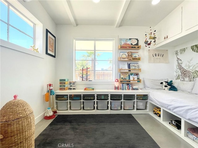 mudroom featuring beamed ceiling and concrete flooring