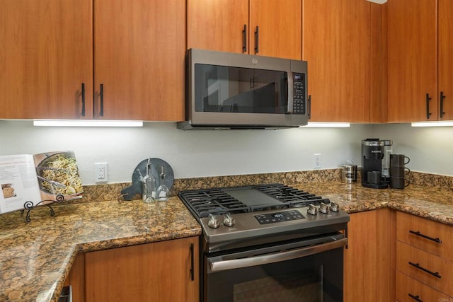 kitchen featuring stone countertops and appliances with stainless steel finishes