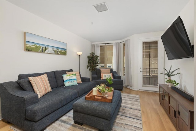 living area featuring visible vents and light wood-style flooring