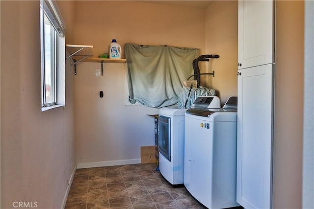 laundry area with cabinets and separate washer and dryer