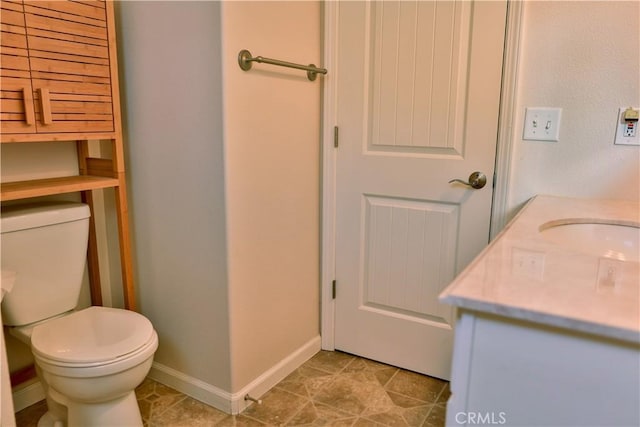 bathroom with tile patterned floors, vanity, and toilet