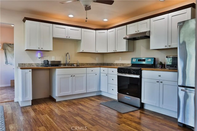 kitchen with stainless steel refrigerator, white cabinets, dark hardwood / wood-style floors, and range