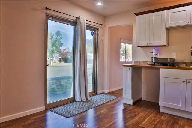 kitchen featuring white cabinets and dark wood-type flooring