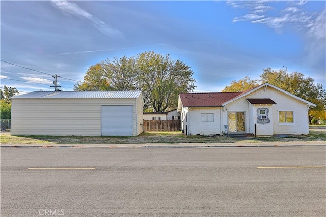 exterior space with a garage and an outdoor structure