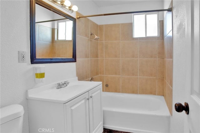 bathroom featuring bathing tub / shower combination, vanity, and toilet