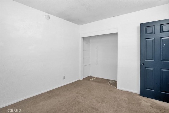 unfurnished bedroom with baseboards, a closet, and light colored carpet