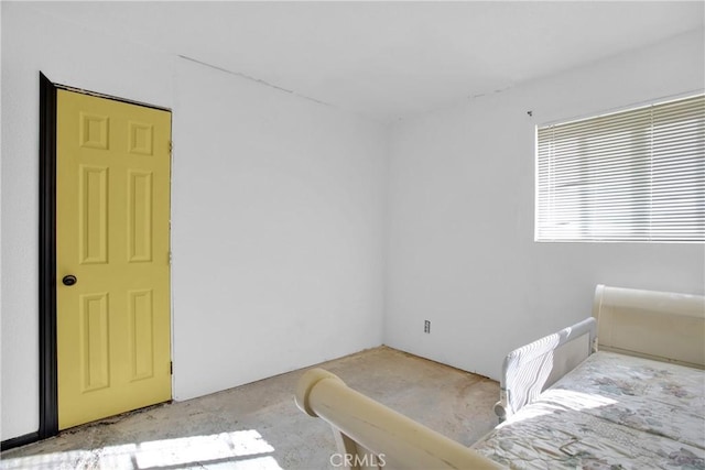 bedroom featuring concrete flooring