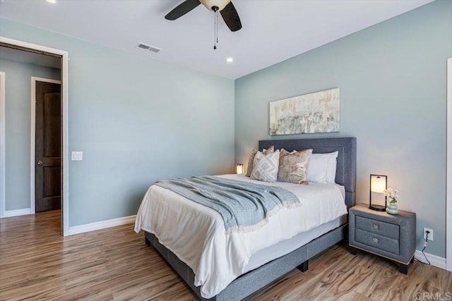 bedroom with hardwood / wood-style flooring and ceiling fan