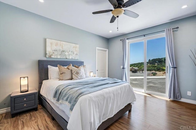 bedroom featuring access to exterior, wood-type flooring, and ceiling fan