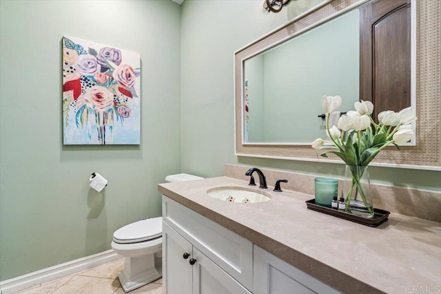 bathroom with tile patterned flooring, vanity, and toilet