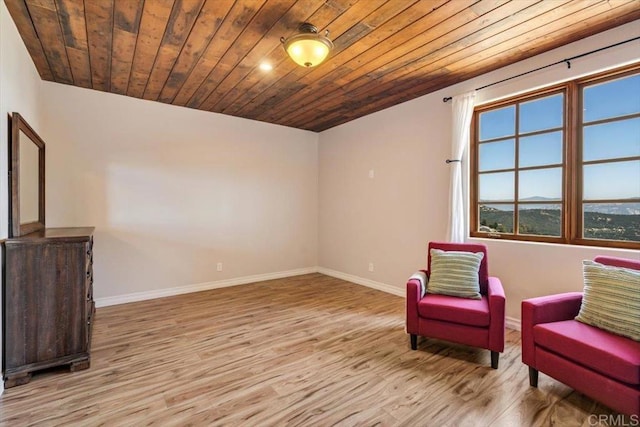 living area with wood ceiling and light hardwood / wood-style floors