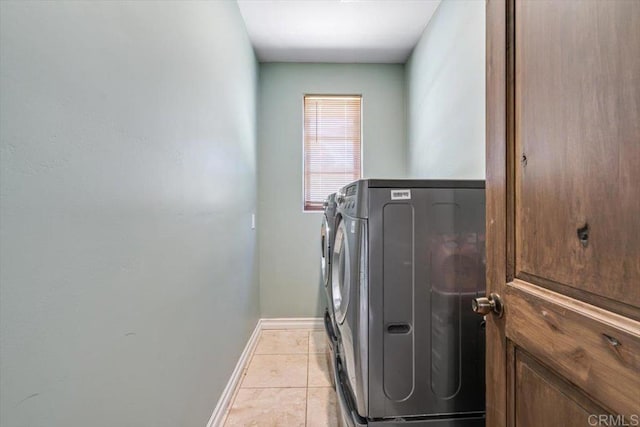 laundry room featuring light tile patterned floors and washer and dryer