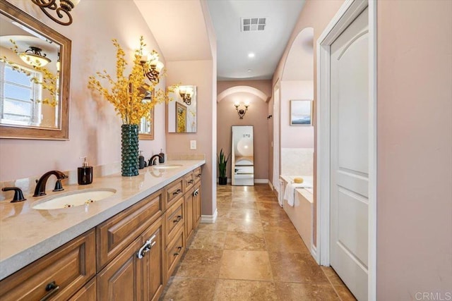 bathroom with vanity and a tub to relax in