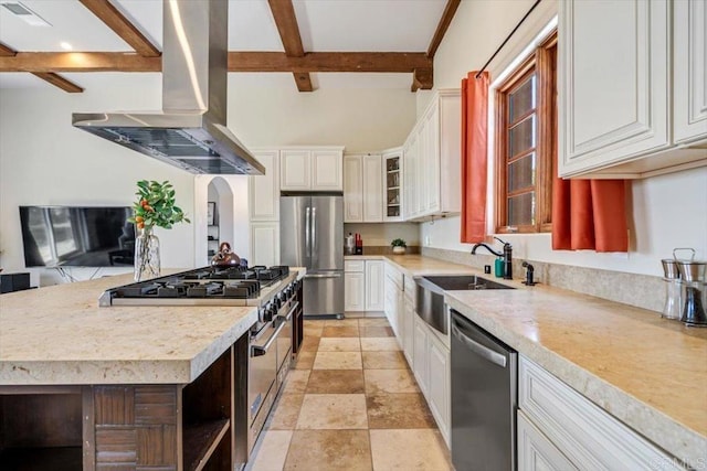 kitchen featuring beam ceiling, white cabinetry, stainless steel appliances, and range hood