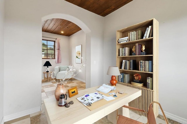 office with arched walkways, wood ceiling, and baseboards