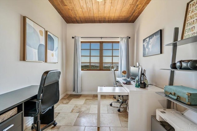 home office featuring stone finish floor, wood ceiling, and baseboards