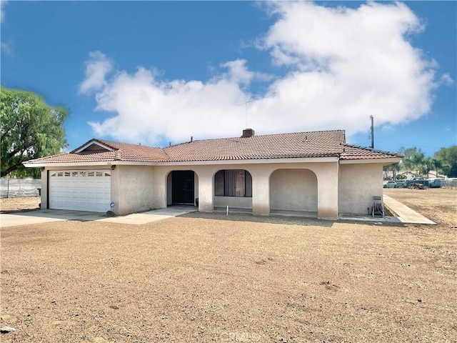 mediterranean / spanish home with a garage