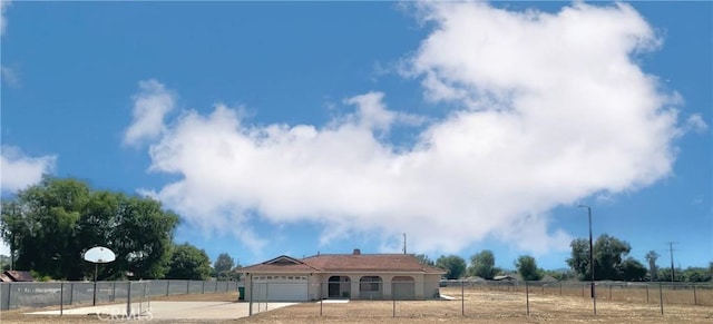 view of front of home with a rural view