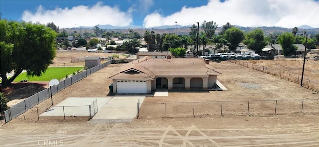 view of front of home with a mountain view and a garage