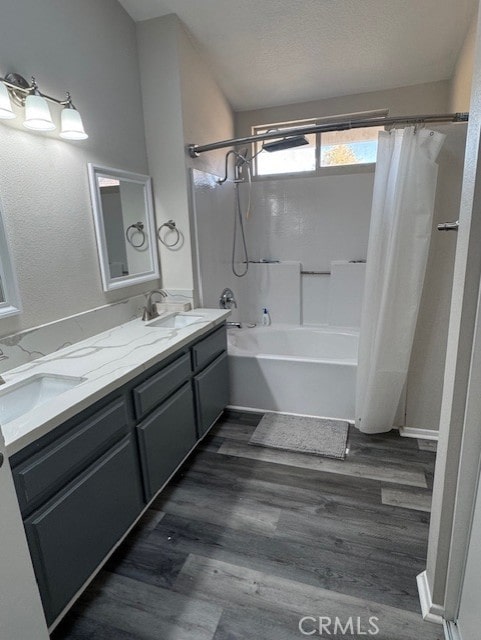 bathroom featuring shower / bath combination with curtain, wood-type flooring, a textured ceiling, and vanity