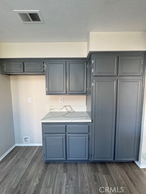 kitchen with dark hardwood / wood-style floors and a textured ceiling