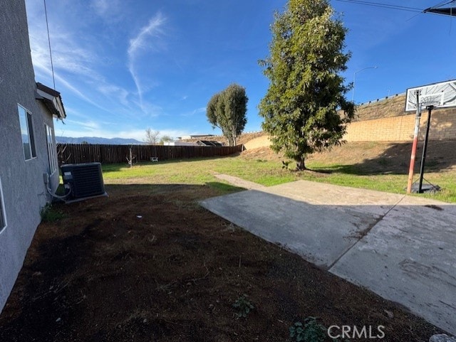 view of yard featuring central AC and a patio area