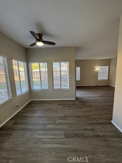 spare room featuring ceiling fan and dark hardwood / wood-style floors