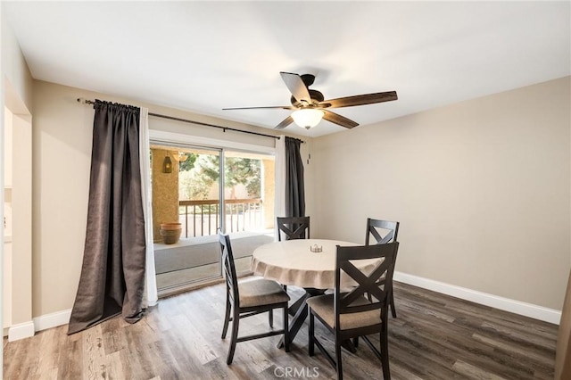 dining area with wood-type flooring and ceiling fan