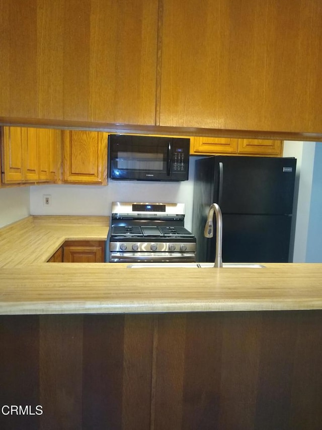 kitchen with sink and black appliances