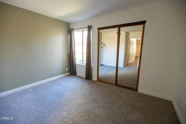 unfurnished bedroom featuring a closet and carpet