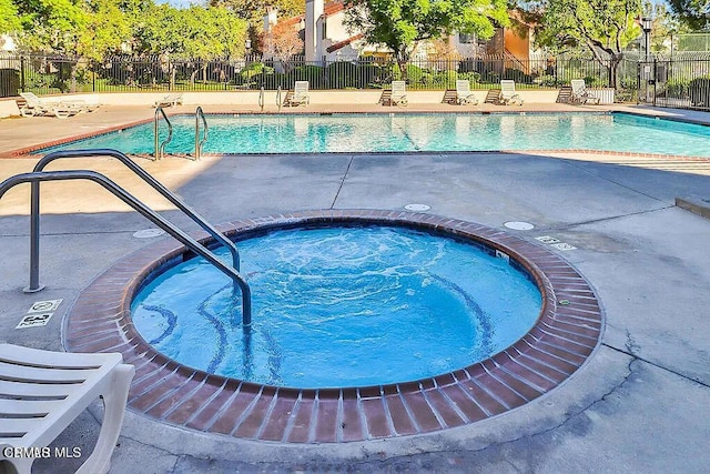 view of swimming pool with a community hot tub and a patio