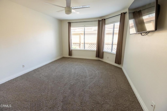 spare room featuring carpet floors and ceiling fan