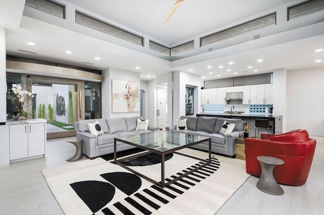 tiled living room featuring sink