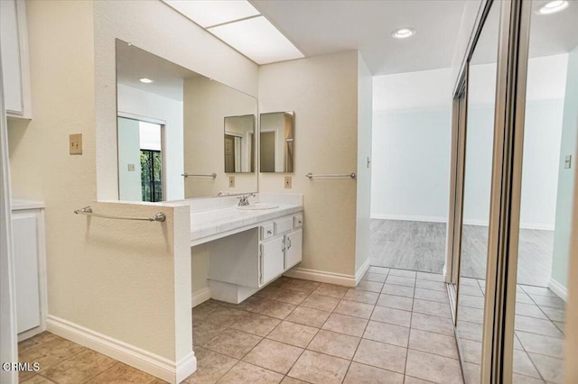 bathroom featuring tile patterned flooring and vanity