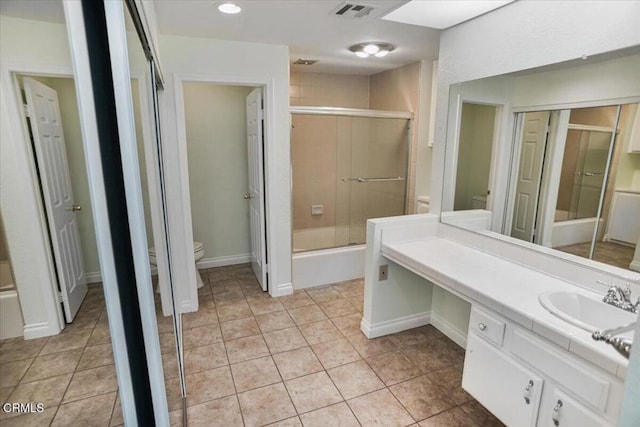 bathroom with tile patterned flooring, vanity, and toilet