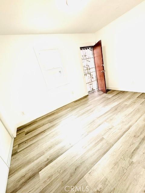 unfurnished room with wood finished floors