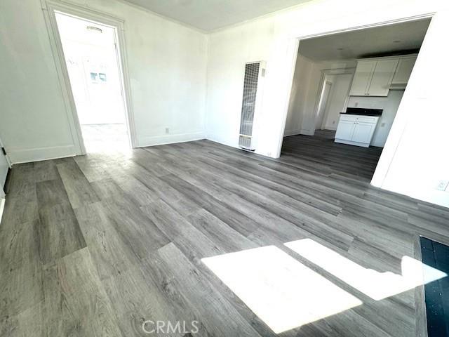 unfurnished living room featuring wood finished floors