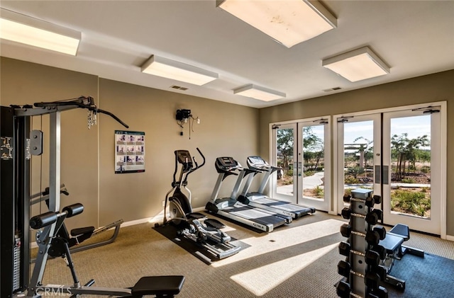 interior space with carpet, visible vents, baseboards, and french doors