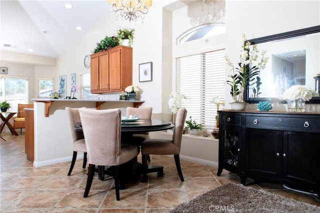 dining room featuring high vaulted ceiling and a chandelier