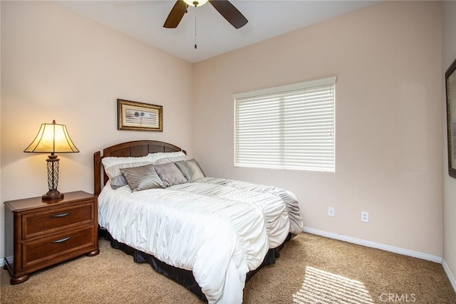 bedroom with light carpet, ceiling fan, and baseboards