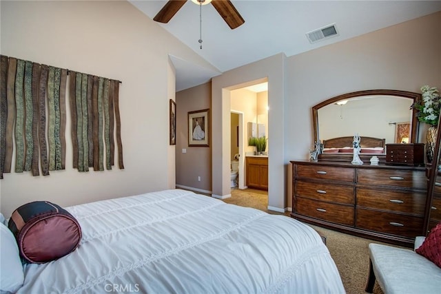 bedroom featuring lofted ceiling, visible vents, light carpet, connected bathroom, and baseboards