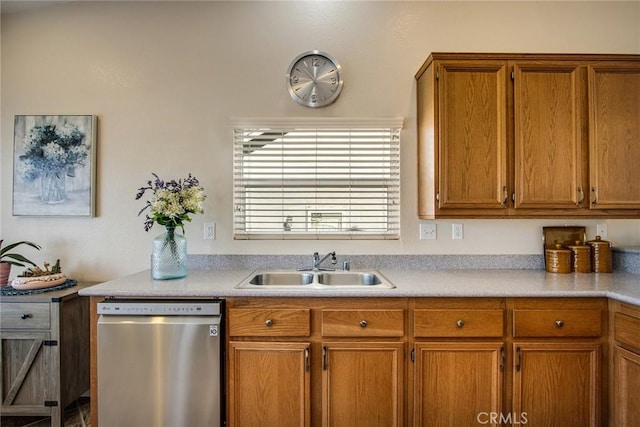 kitchen featuring a sink, brown cabinetry, light countertops, and stainless steel dishwasher