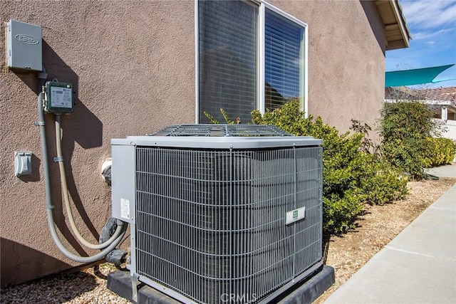 details featuring central AC unit and stucco siding