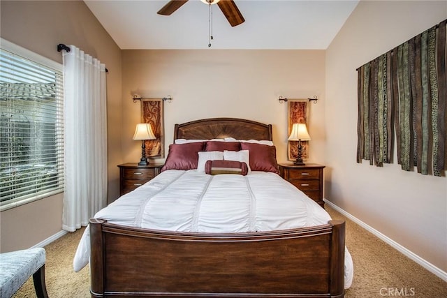 bedroom with lofted ceiling, multiple windows, and baseboards