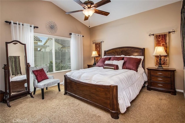 bedroom featuring light carpet, ceiling fan, baseboards, and vaulted ceiling