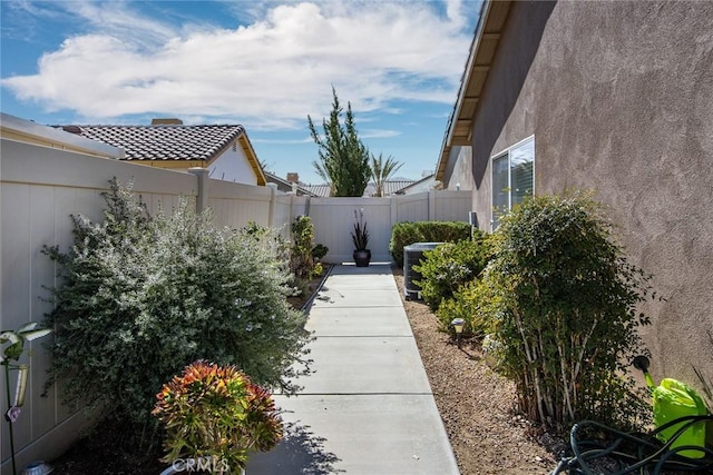 view of yard with central AC unit and a fenced backyard