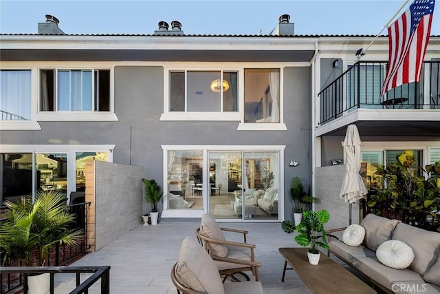 back of house with a patio and a balcony