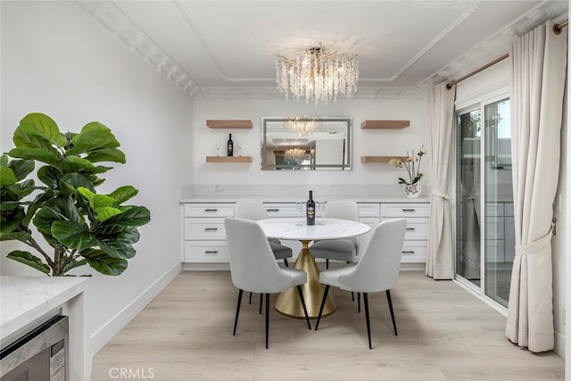 dining area featuring light wood-type flooring, wine cooler, and a notable chandelier