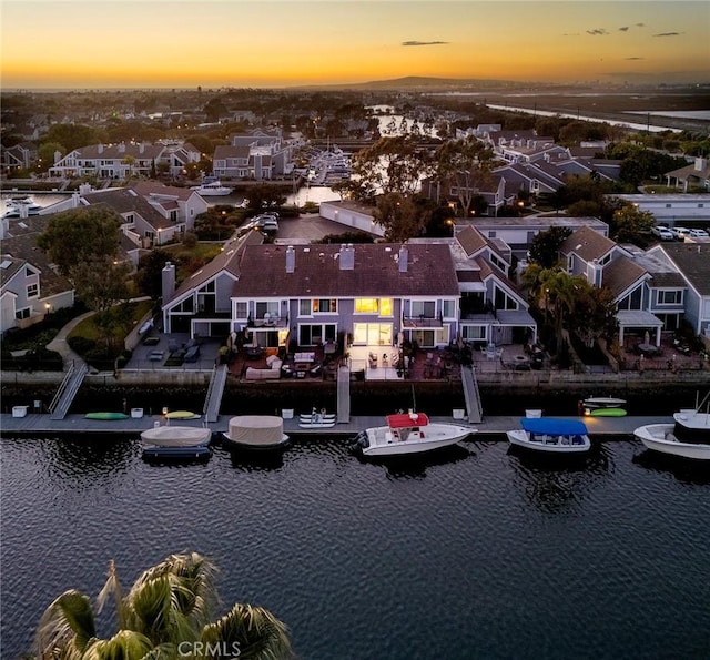 aerial view at dusk with a water view